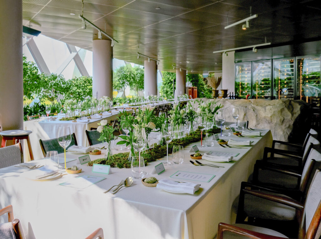 A long banquet table set up for a wedding at Marguerite restaurant inside the Flower Dome, Gardens by the Bay