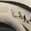 Four runners ascend a curved concrete ramp in a multi-storey car park, captured mid-stride from above during an On Squad Race event.