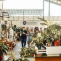 Visitors browsing plants and market vendors inside the Sing See Soon nursery at 5 Simei Lane, Singapore.