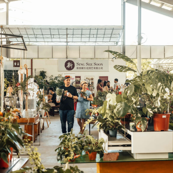 Visitors browsing plants and market vendors inside the Sing See Soon nursery at 5 Simei Lane, Singapore.