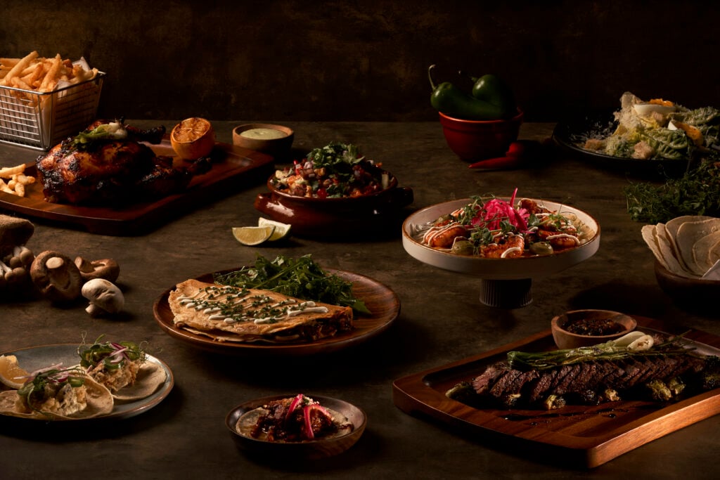 A spread of tacos, fire roasted chicken and shared plates at 11 Westside, Asia Square
