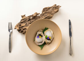 Oysters with caviar and edible flowers, a fine dining dish from Singapore's fine dining restaurant scene