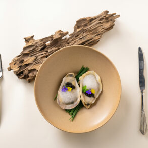 Oysters with caviar and edible flowers, a fine dining dish from Singapore's fine dining restaurant scene