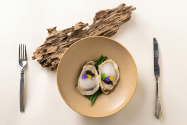 Oysters with caviar and edible flowers, a fine dining dish from Singapore's fine dining restaurant scene