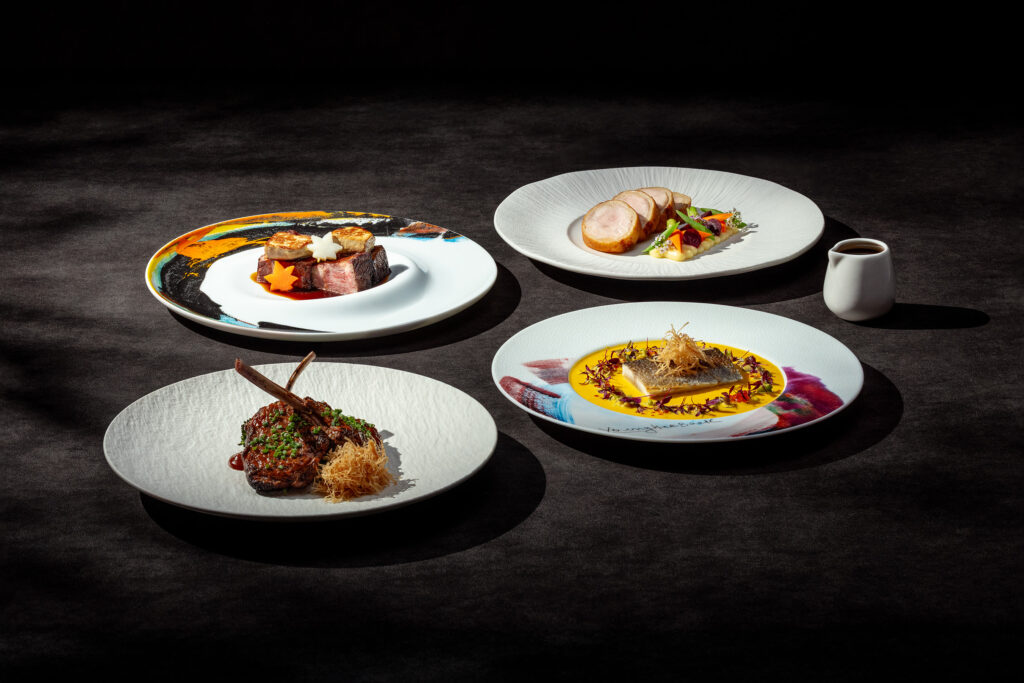 Wagyu beef with foie gras, pork roulade, fish and lamb chop plated at Akira Back, a fine dining restaurant in Singapore