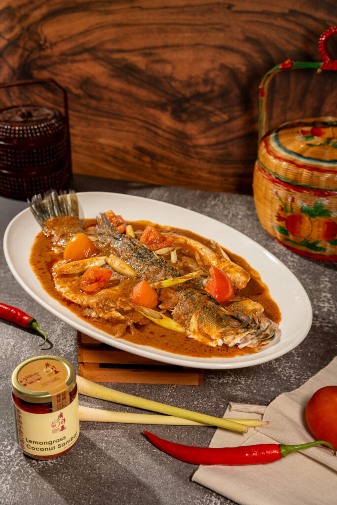Riverside Steamed Seabass in a savoury sauce with tomato and lemongrass, served alongside a jar of Kwong Cheong Thye lemongrass coconut sambal