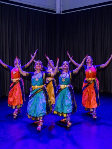 Bharatanatyam dancers in colourful costumes perform on stage at SIFAS Singapore Indian Fine Arts Society