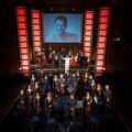 re:mix chamber orchestra and cast take a bow on stage at Wild Rice's Tunggu Sekejap: The P. Ramlee Suite, with a portrait of P. Ramlee projected behind them