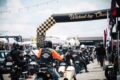 Motorcyclists ride under the checkered Wicked by Choice arch at Wicked Wallop Drop in Singapore.