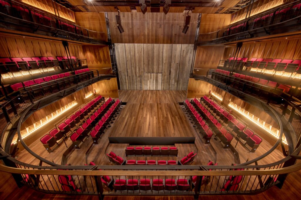 Interior of Wild Rice at Funan showing the Ngee Ann Kongsi Theatre thrust stage and red-seated auditorium