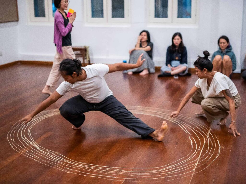 The Theatre Practice Singapore performers in an intimate studio production with audience seated on the floor