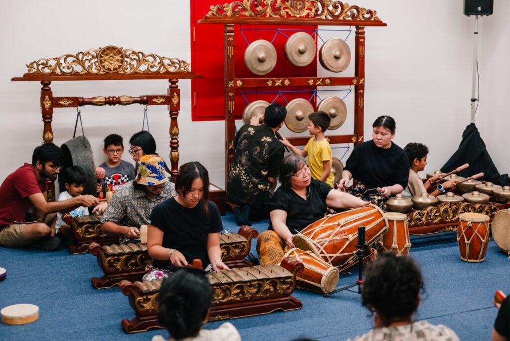 Visitors of all ages play gamelan instruments at a hands-on workshop during A Date with Tradition at Stamford Arts Centre, Singapore.