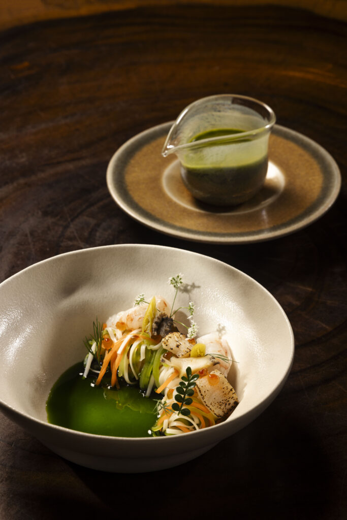 A cold seafood small plate of prawns, abalone and wheat noodles in green tiger's milk, served alongside a jug of the sauce at Birds of a Feather.