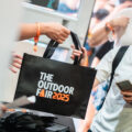 An attendee receives a black tote bag at the past event registration.