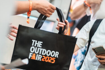 An attendee receives a black tote bag at the past event registration.
