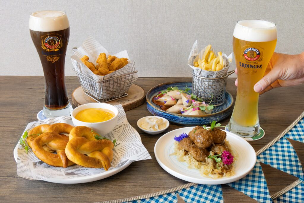 Oktoberfest spread at Holiday Inn Singapore Atrium with pretzels, chicken schnitzel bites, fries and Erdinger beer