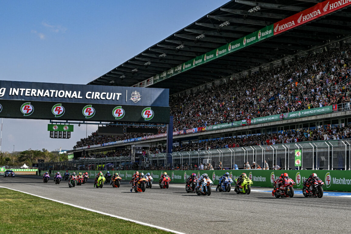 MotoGP riders take the start at Chang International Circuit in Buriram, Thailand, with a packed grandstand behind