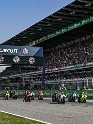MotoGP riders take the start at Chang International Circuit in Buriram, Thailand, with a packed grandstand behind