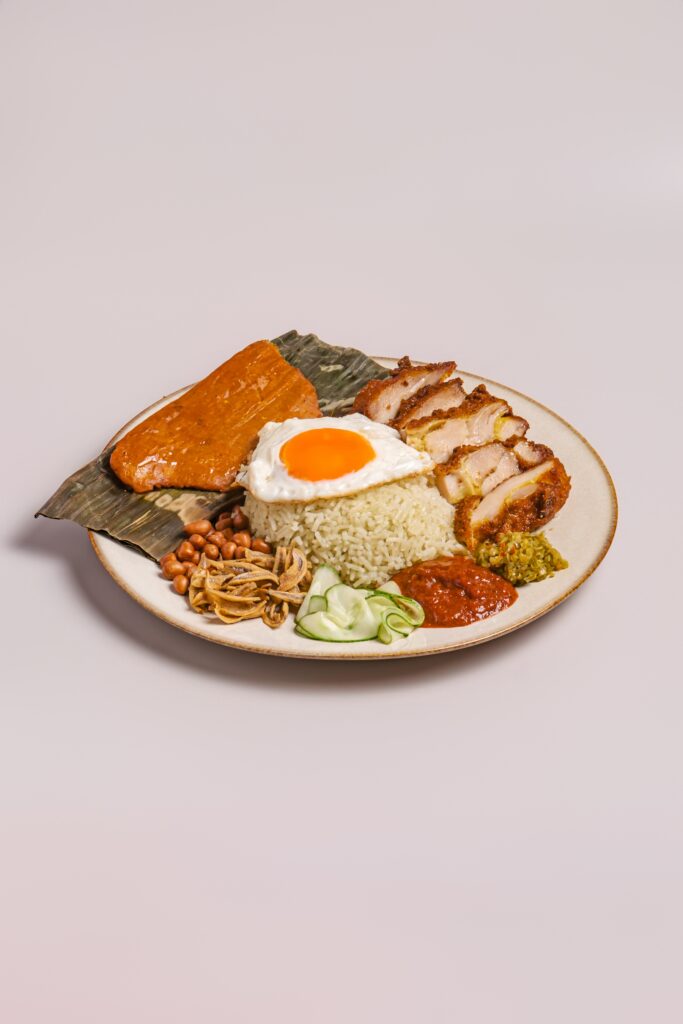 A plate of nasi lemak with fried chicken cutlet, otah, fried egg, peanuts and sambal at Chin Mee Chin.