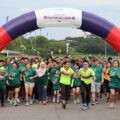 Runners of all abilities crossing the start arch at Runninghour's Run For Inclusion, cheering as they set off from Bedok Reservoir