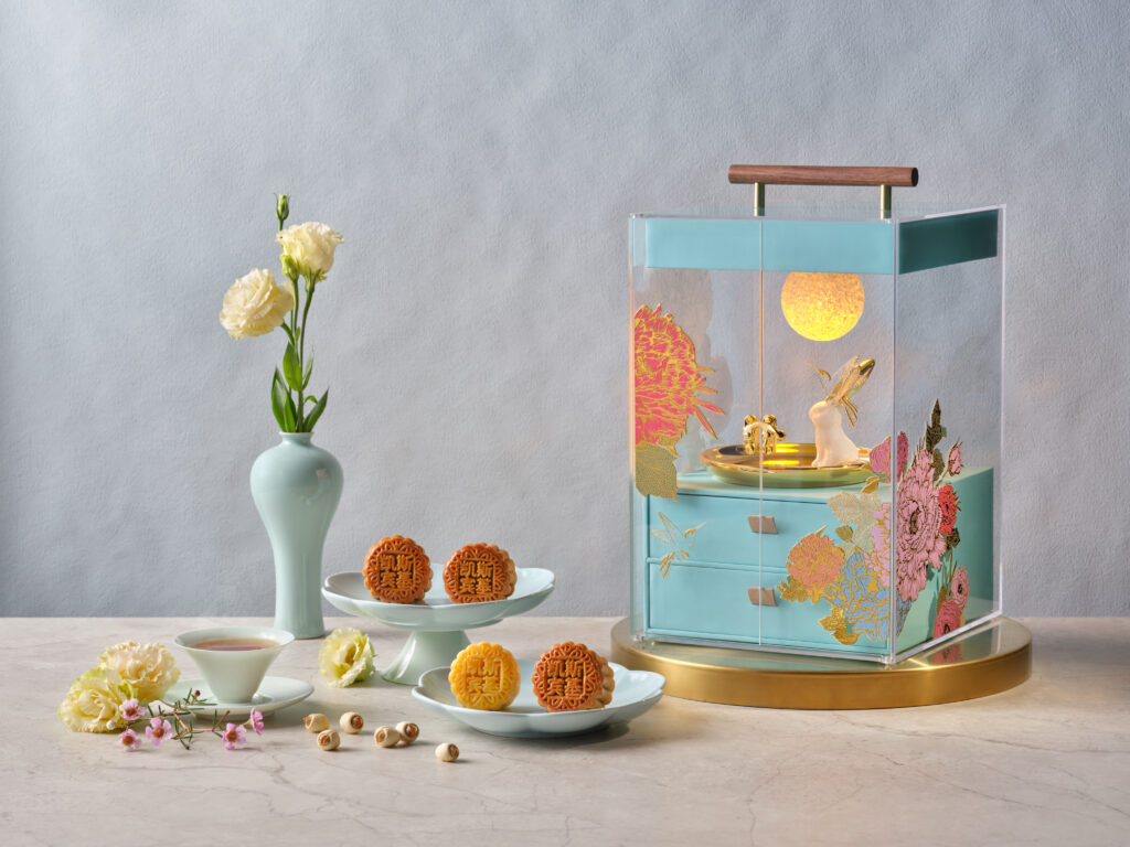 The Capitol Kempinski Hotel Singapore musical mooncake gift box with floral motifs and bunny ornament, alongside mini baked mooncakes, Mid-Autumn 2026 collection