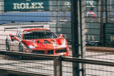 A race car speeding past Rolex signage on the Marina Bay Street Circuit during Singapore Grand Prix weekend