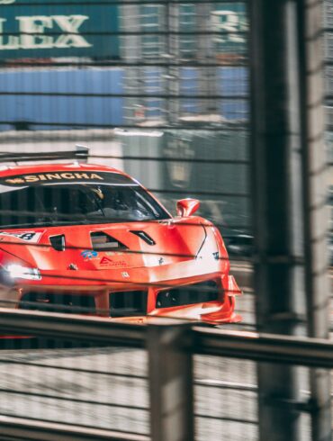 A race car speeding past Rolex signage on the Marina Bay Street Circuit during Singapore Grand Prix weekend