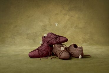PUMA x ROSÉ Speedcat sneakers in burgundy and brown nubuck leather with wrapped laces, stacked on an olive green backdrop with white butterflies.