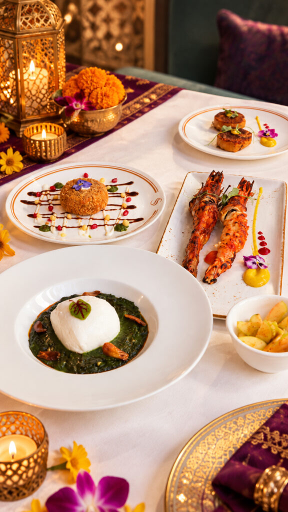 SanSara’s Diwali Feast set menu at Grand Copthorne Waterfront Singapore, with Burrata Palak, Paprika Tandoori Prawns, a Breaded Cutlet, Vegetable Shami Kebab and Green Apple Kachumber, set beside brass lanterns and marigolds.