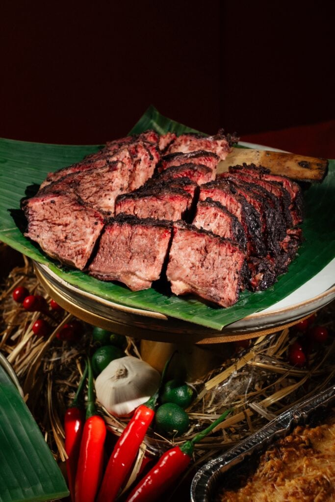 liced Signature Five Spice Smoked Beef Short Ribs from South & East on a banana leaf, with red chillies and calamansi