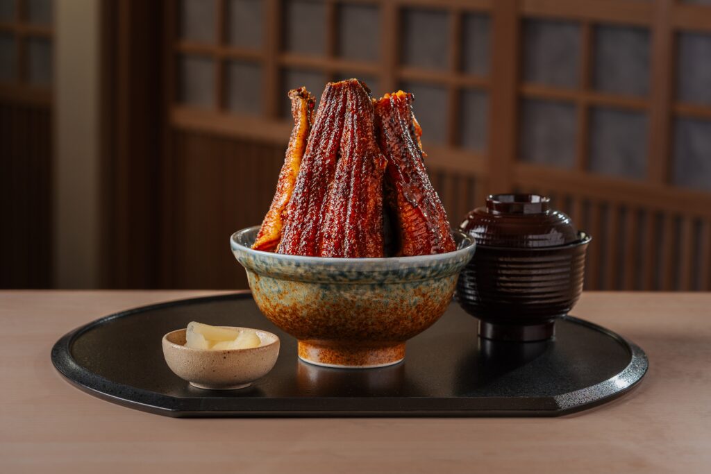 Unagi Mountain at Unagi Yondaime Kikukawa, Raffles City, with whole kabayaki eels stacked upright over rice beside miso soup.