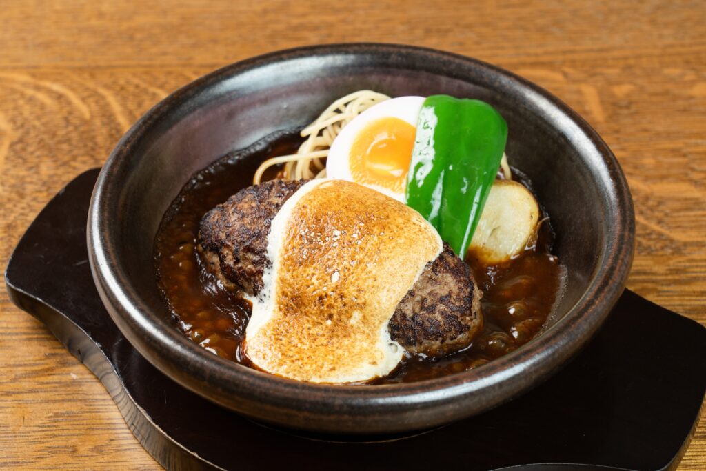 Signature Yamamoto Hamburg at Lau Pa Sat, a beef and pork patty with torched cheese in demi-glace, with egg, green pepper and potato.